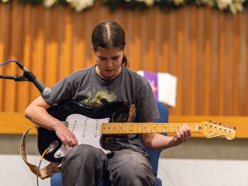 Student performing guitar at Da Capo Academy recital
