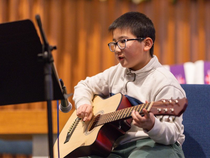 Philip performing guitar at Da Capo Academy of Music