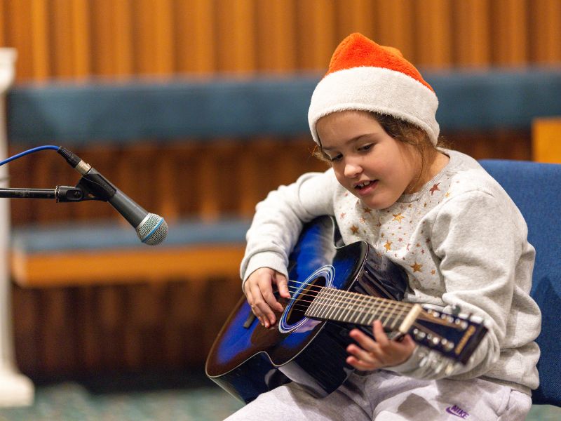 Victoria performing guitar at Da Capo Academy of Music